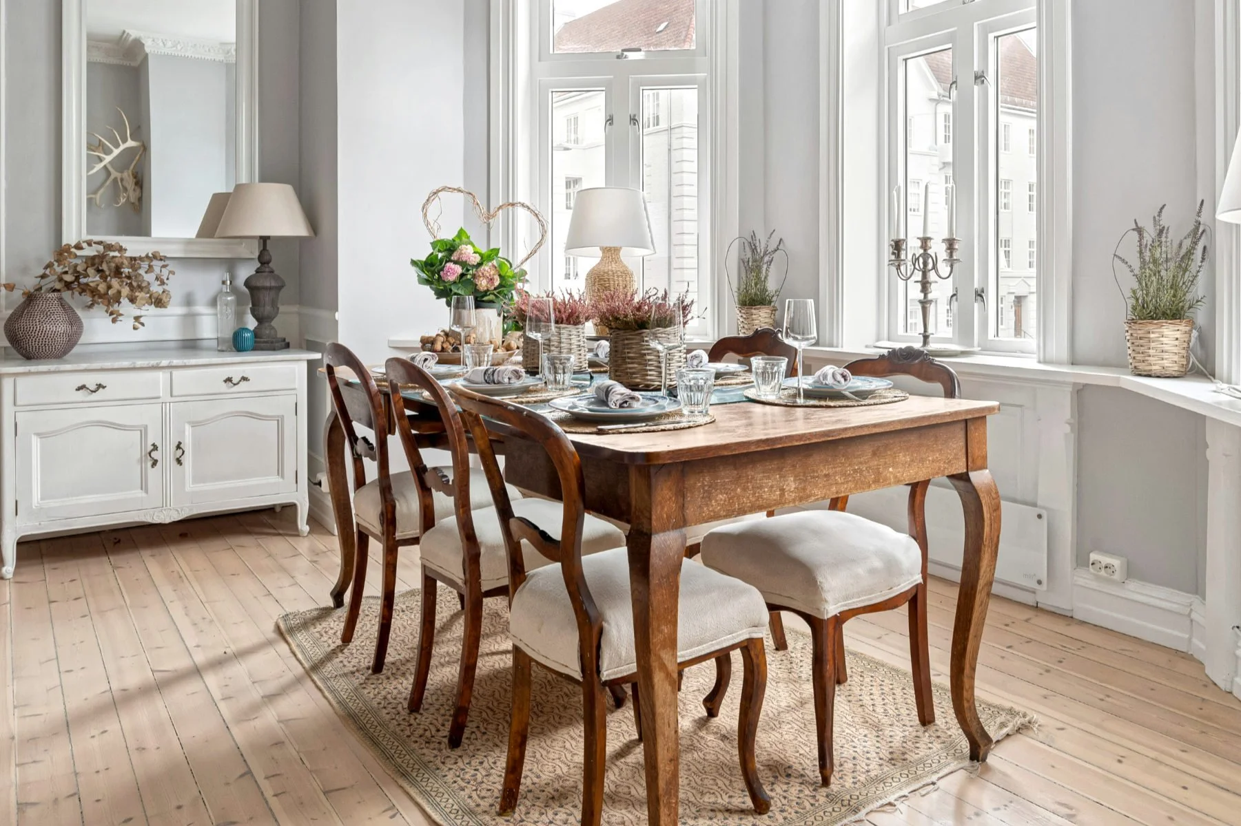 Classic farmhouse dining table made of solid wood, styled with rustic details for a timeless country look