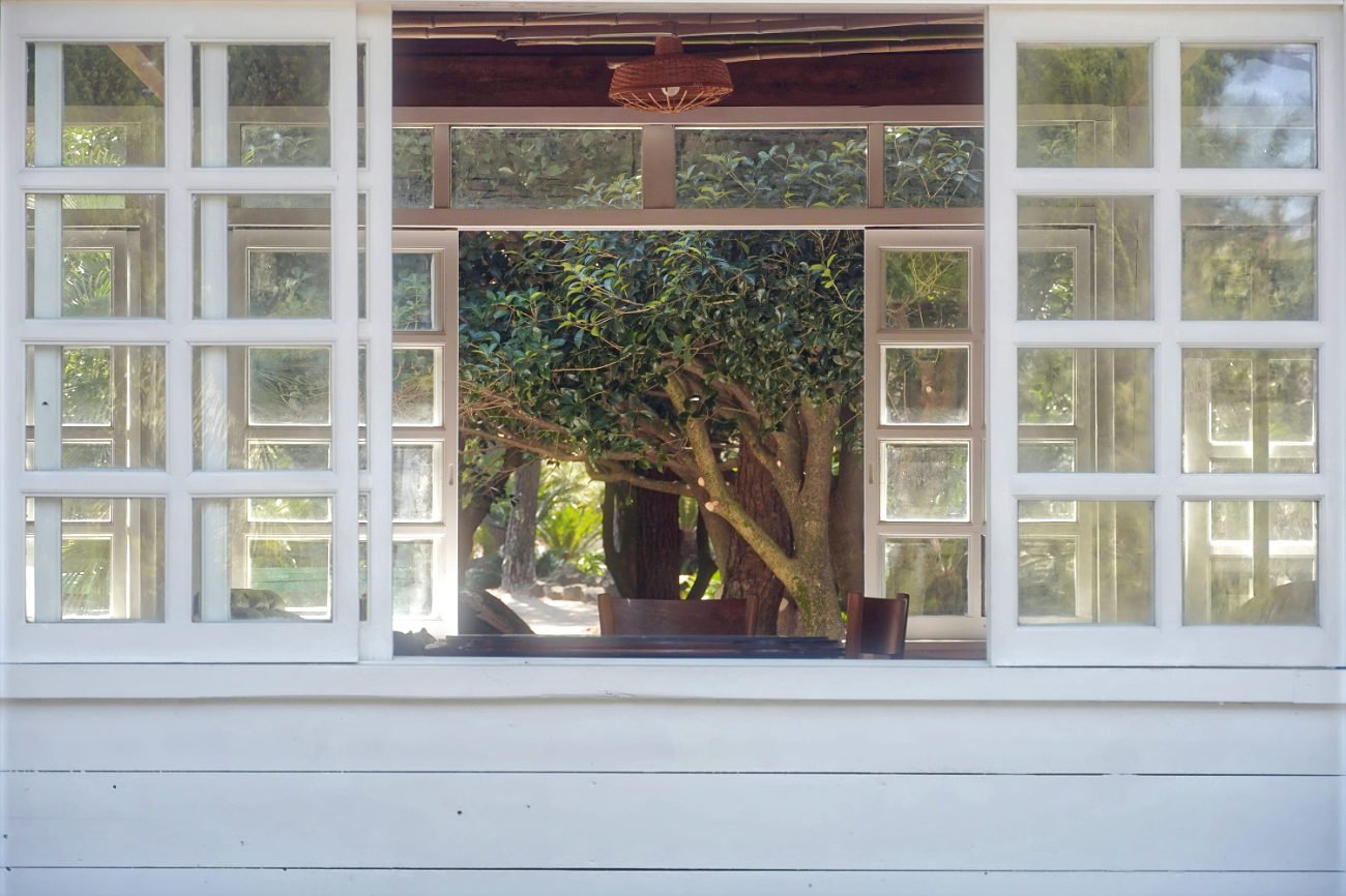 Open terrace windows connecting home interior with garden and fresh outdoor air