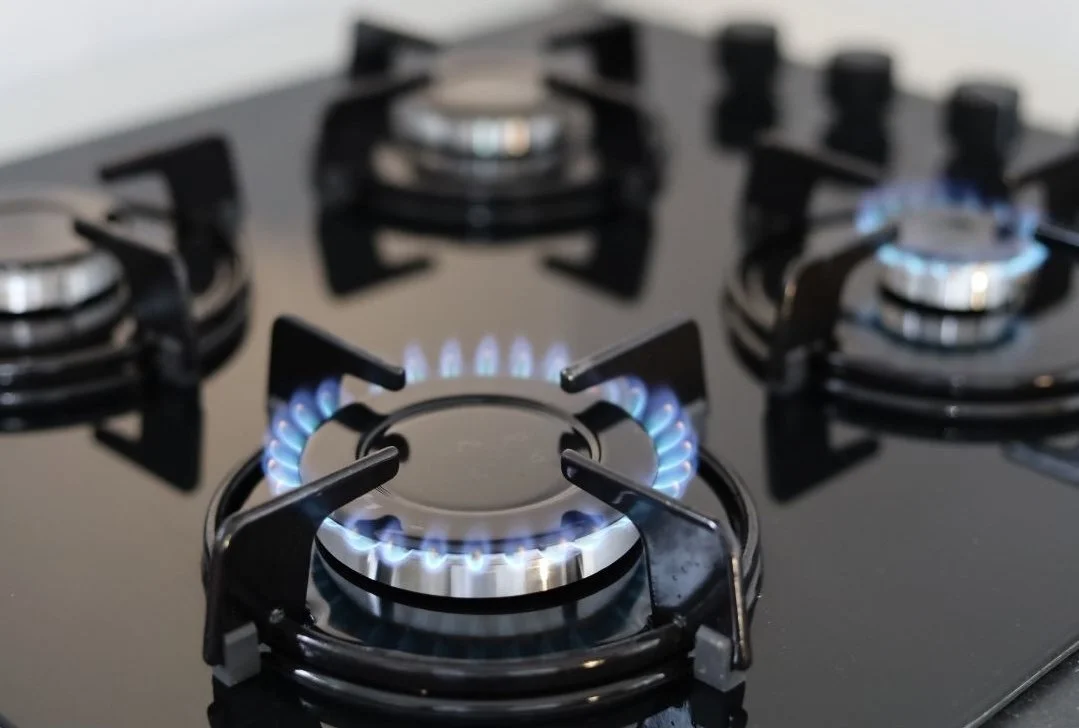 Lit gas stove burners — a visual reminder that cooking appliances can contribute to indoor air pollution