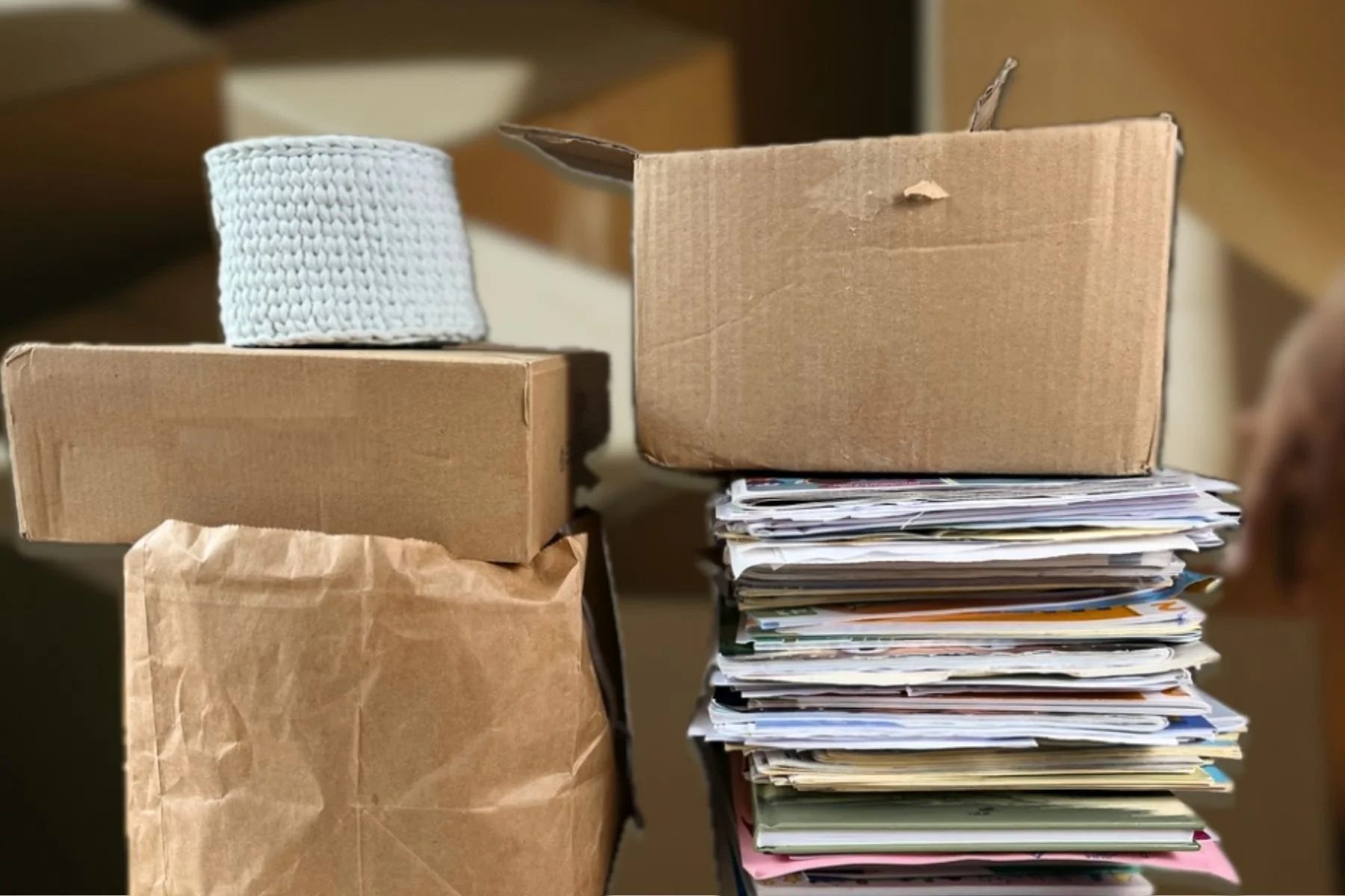tack of cardboard boxes filled with household items, showing clutter and storage buildup.