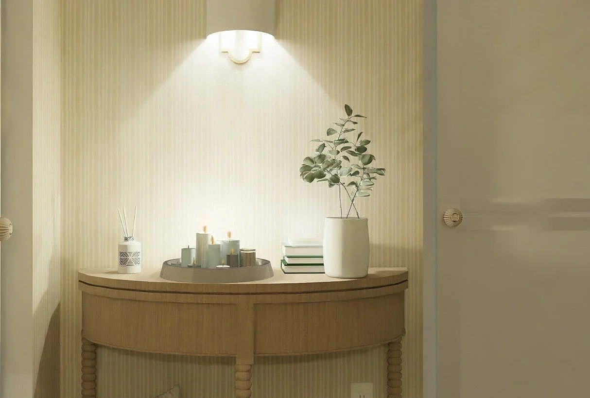 Neutral warm interior with wooden console table and soft candlelight — an example of how to create atmosphere without harsh artificial fragrances.
