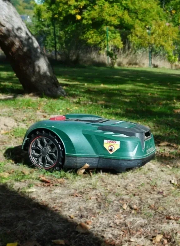 Smart robotic lawn mower maintaining a lush green turf, illustrating modern tech integration for low-maintenance, mindful garden care.