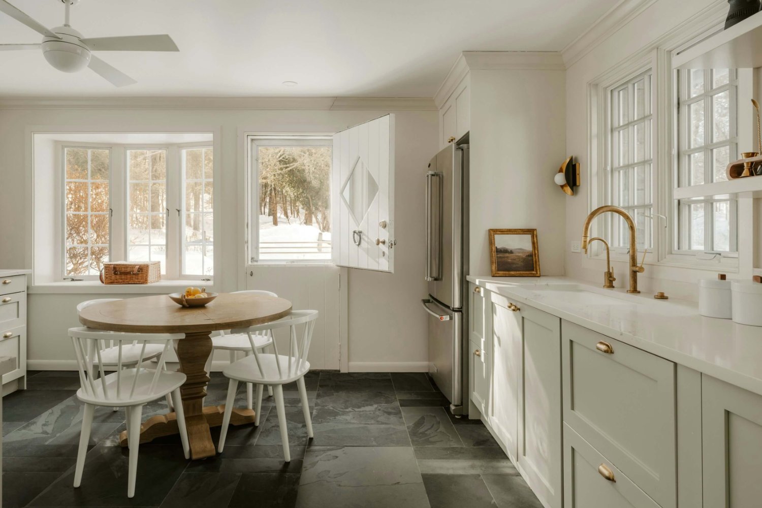 Wide-angle sunny kitchen design with natural light flooding the countertops and cabinets.