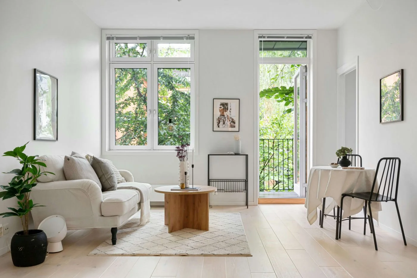Bright open-plan living and dining space with interior doorway frame and wide open patio doors leading to outdoor area, showing indoor-outdoor connection