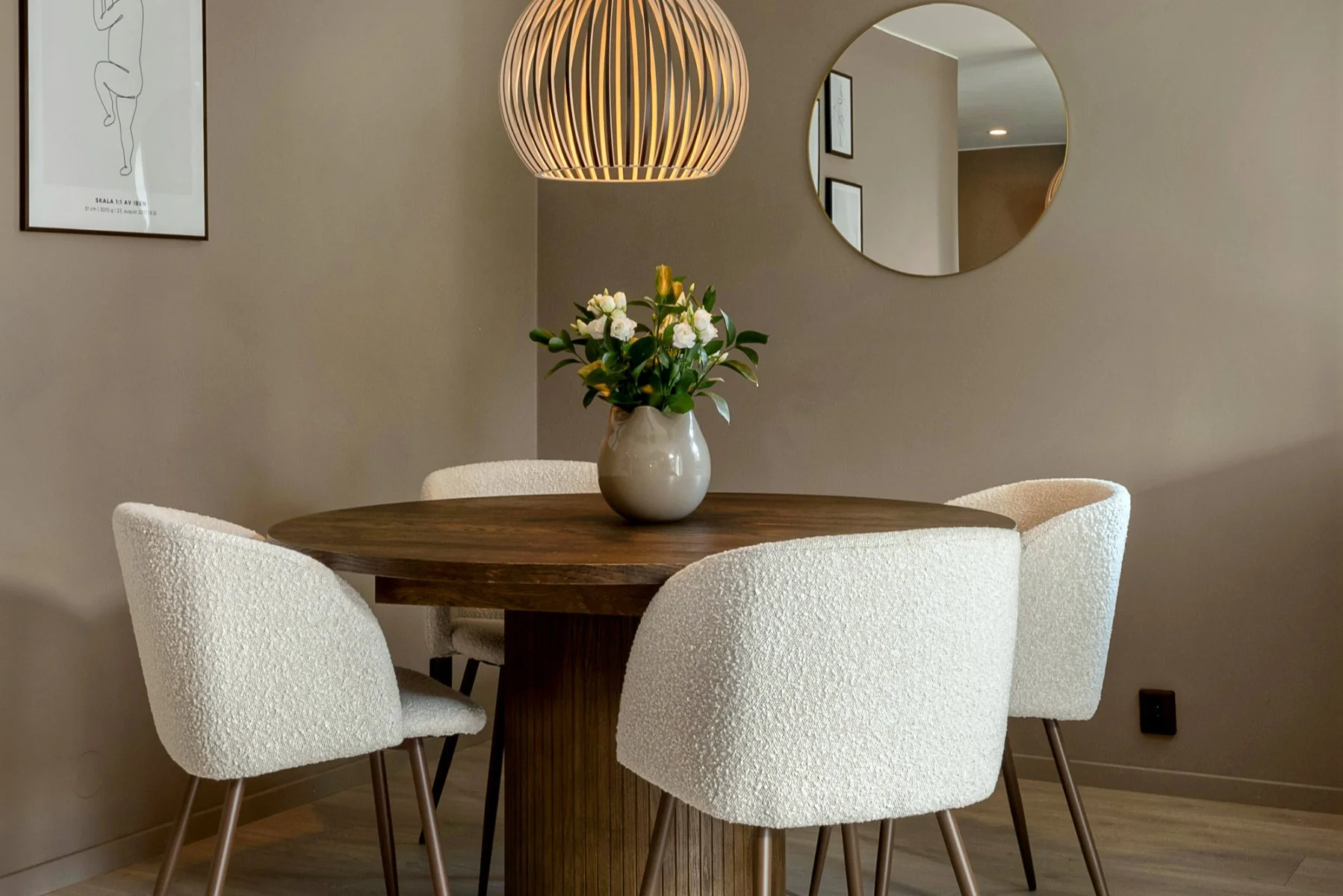 Traditional round pedestal dining table in rich brown wood, blending classic design with warm tones