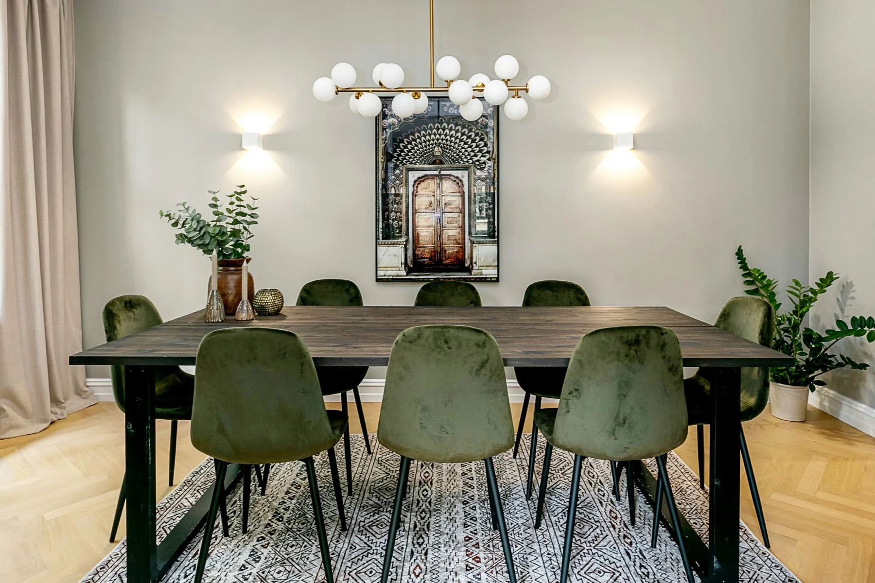 Industrial-style dining table with metal legs and reclaimed wood top, styled for a loft-inspired space.