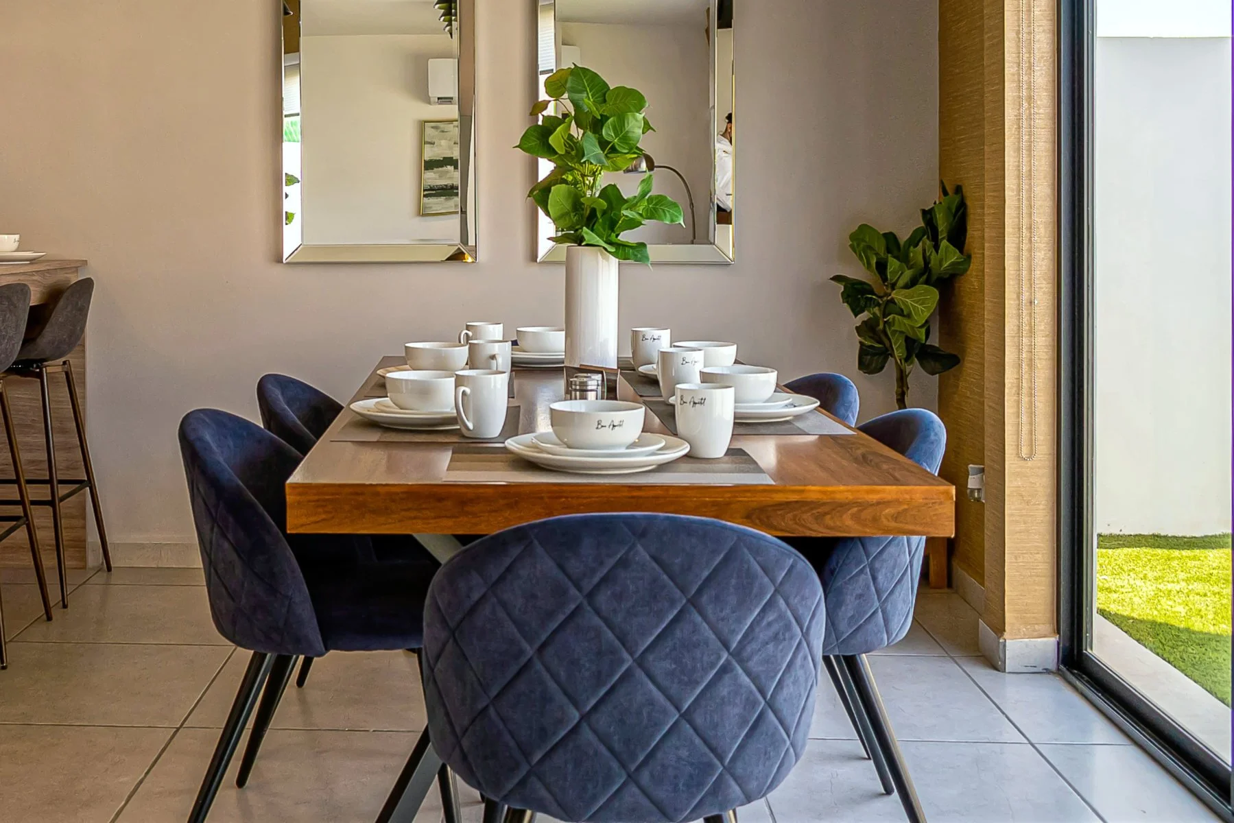 Mid-century modern rectangular dining table in dark wood, paired with upholstered chairs and sleek decor