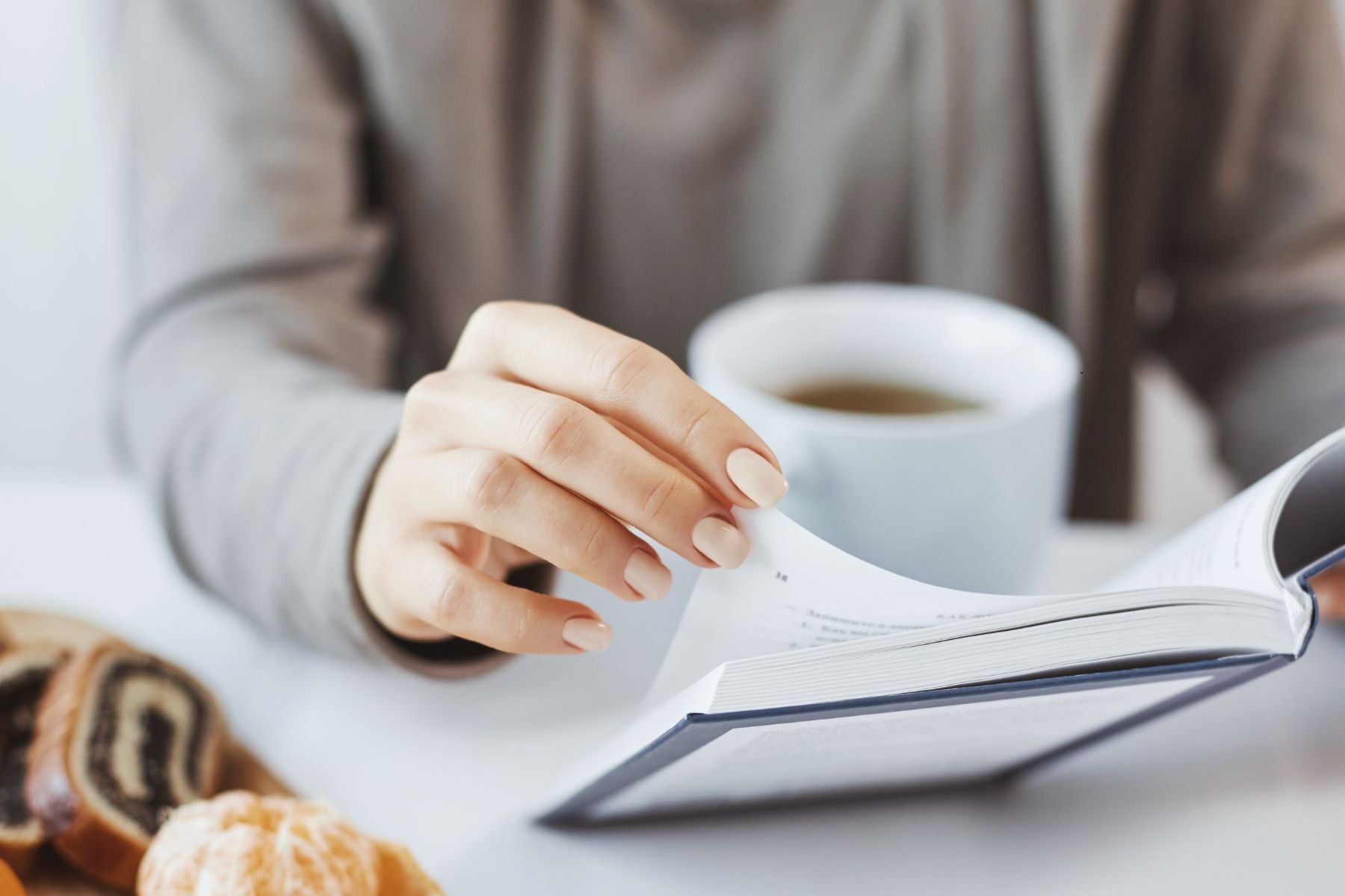 Morning coffee with book and pastry portraying that interiors are made for living.