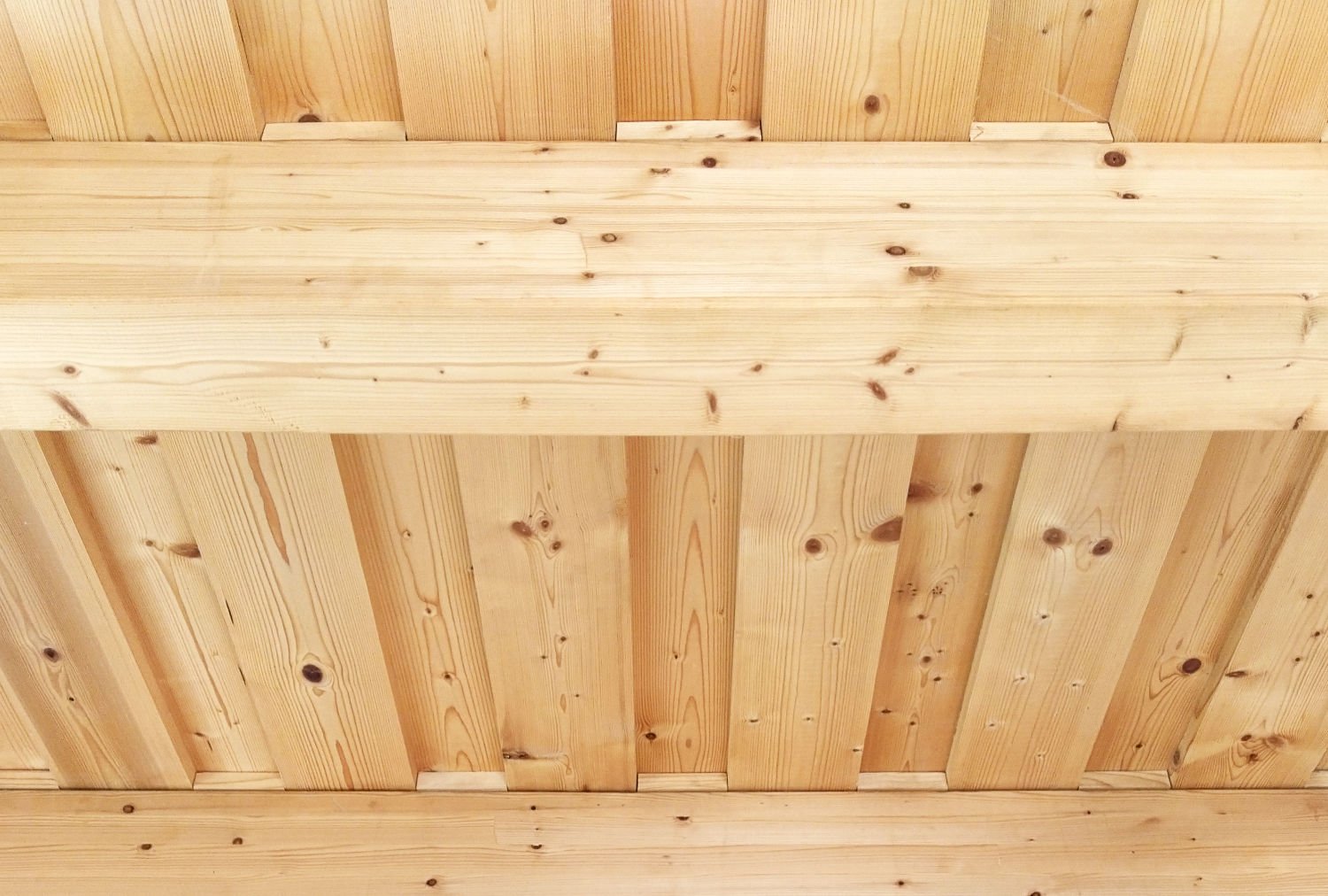 Detail of natural wooden beam ceiling made of spruce