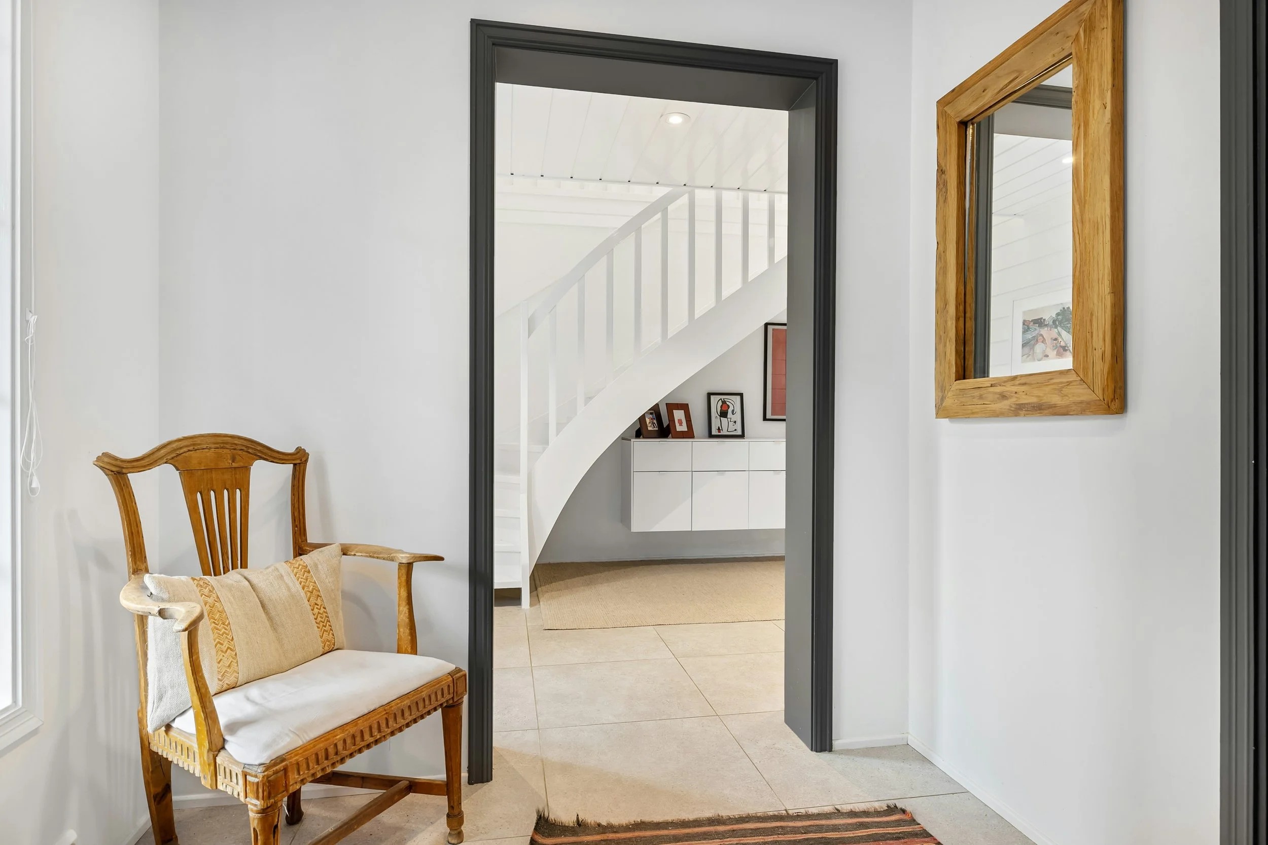 Welcoming entryway layout with black frame doorway illustrating the psychology of thresholds in home design