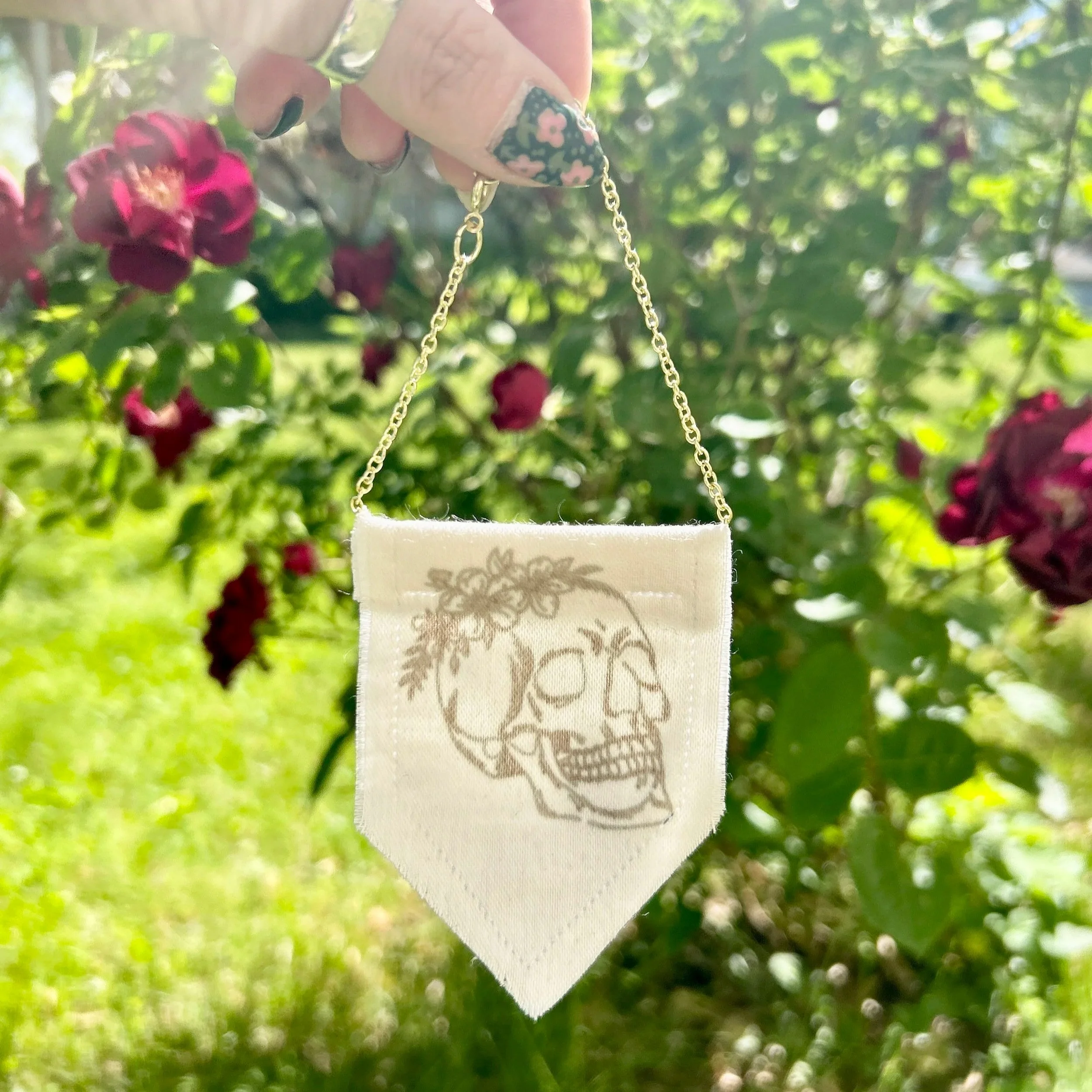 Handmade upcycled white fabric mini banner with black skull and flowers design infused ink design