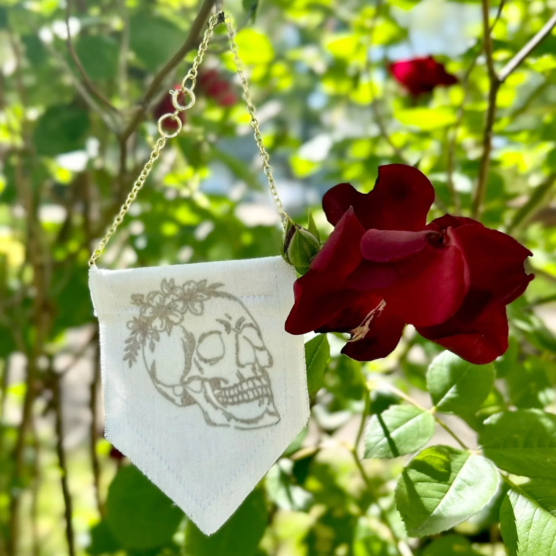 Handmade upcycled white fabric mini banner with black skull and flowers design infused ink design
