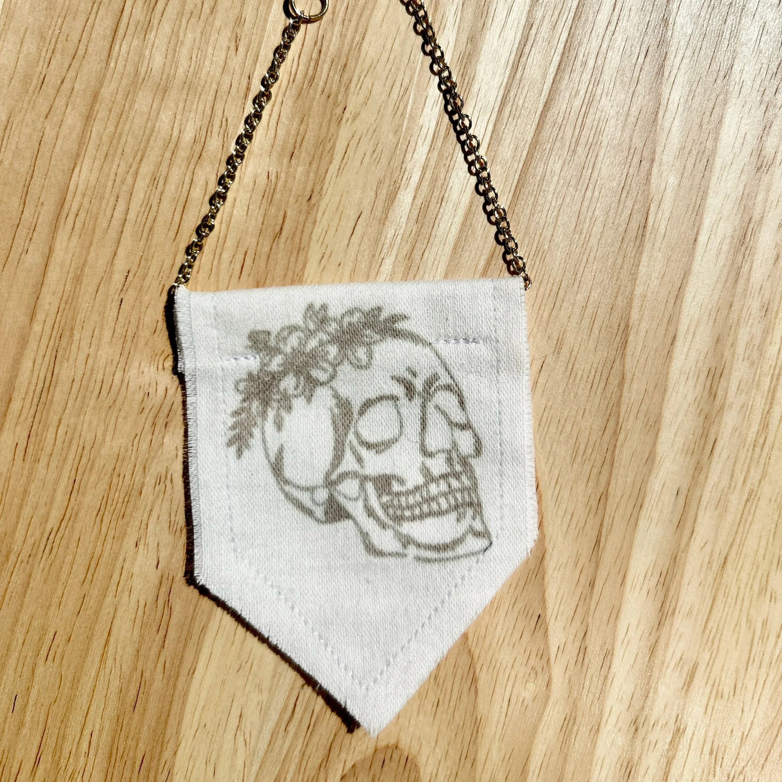 Handmade upcycled white fabric mini banner with black skull and flowers design infused ink design