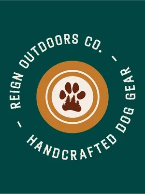 Logo for Reign Outdoors Co. featuring a paw print inside a circular badge, with the words 'Reign Outdoors Co. Handcrafted Dog Gear' around it.
