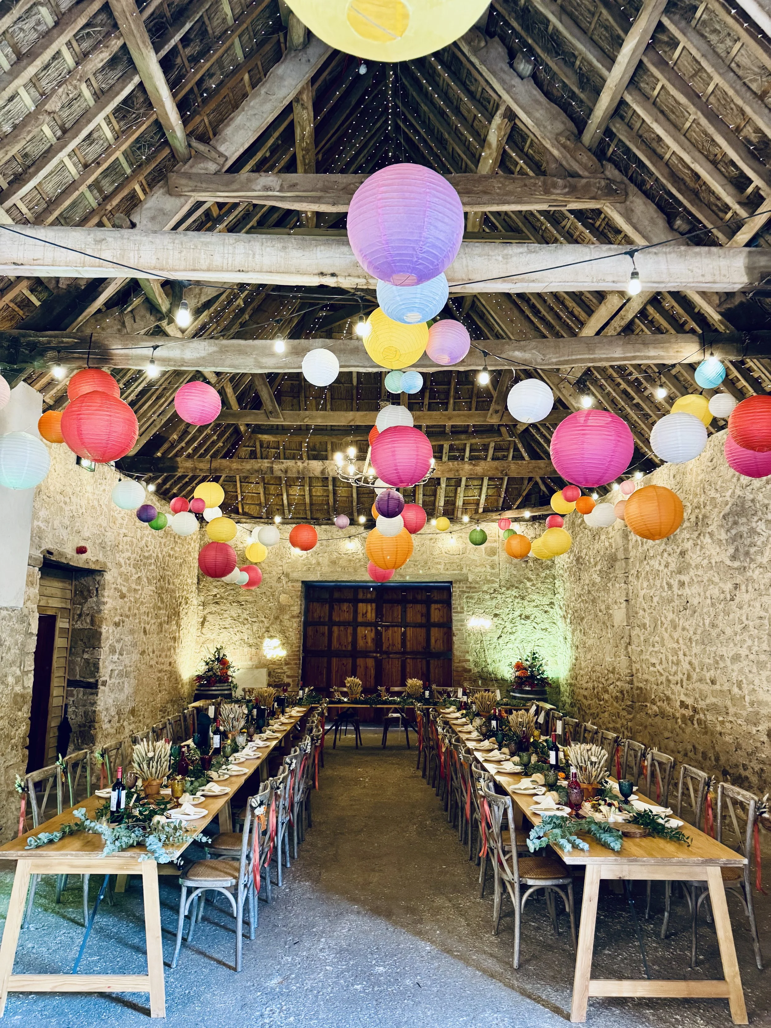 Assorted strawberry shortcake bites topped with whipped cream and fresh strawberry slices, arranged on a tray.