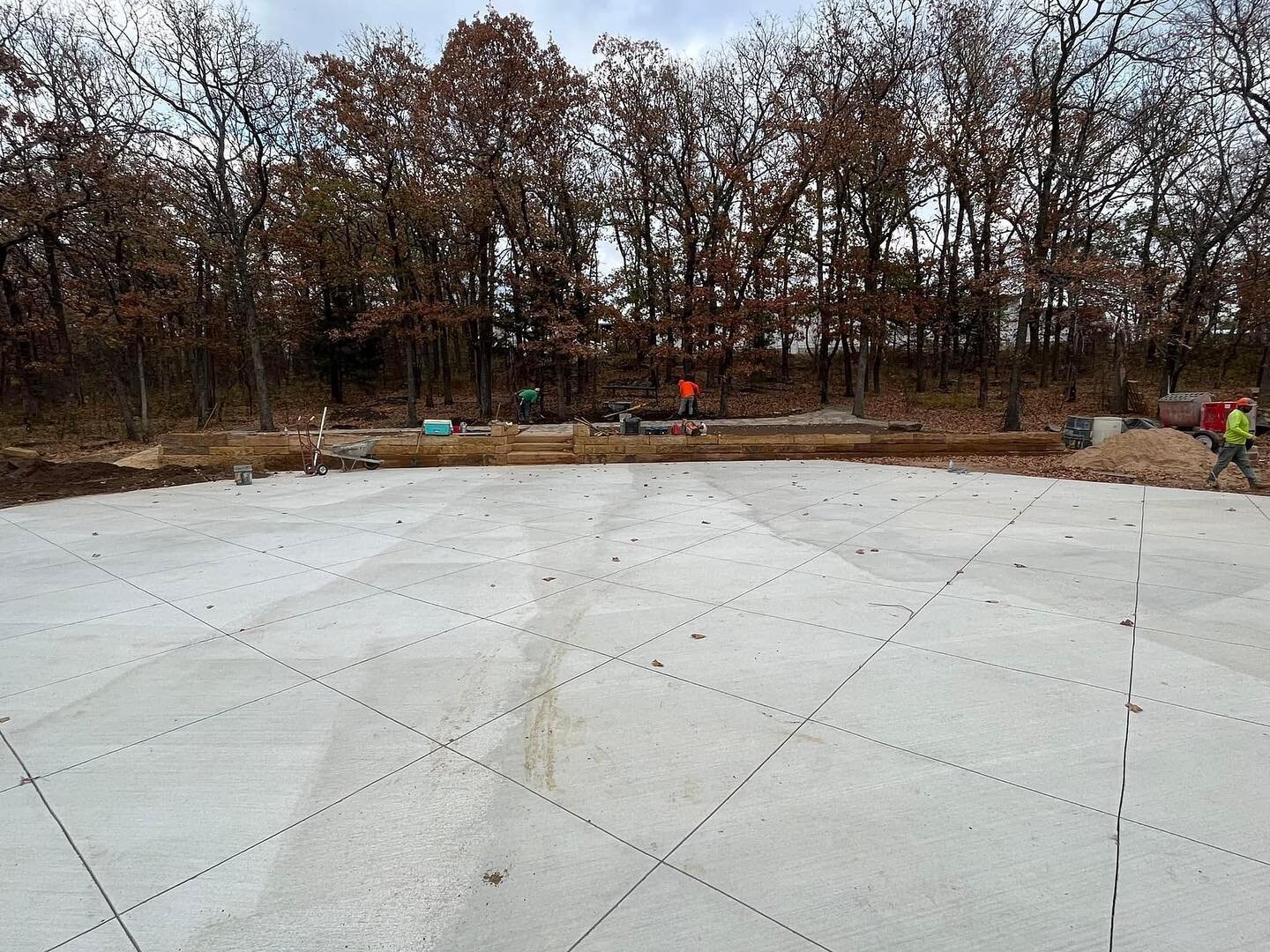 While we wait for more rock to be delivered for the bridge, we put in the retaining wall, beds and rock sidewalks behind the amphitheater stage.  Also got topsoil and hydroseed on the pond dam and slopes.