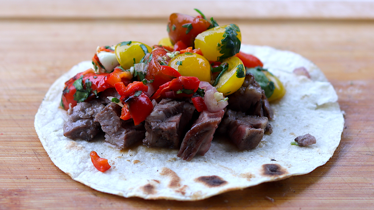 spicy homemade salsa on a grilled skirt steak tack