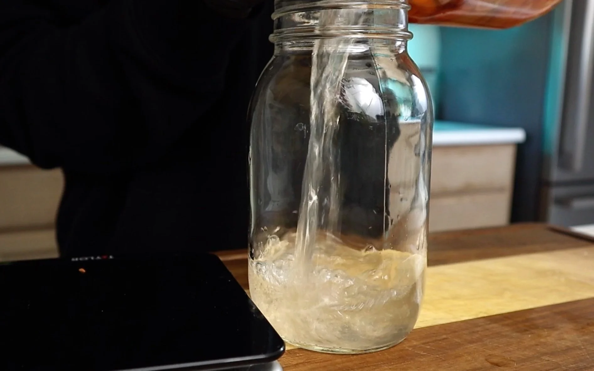 pour weighed water amount into an empty mason jar