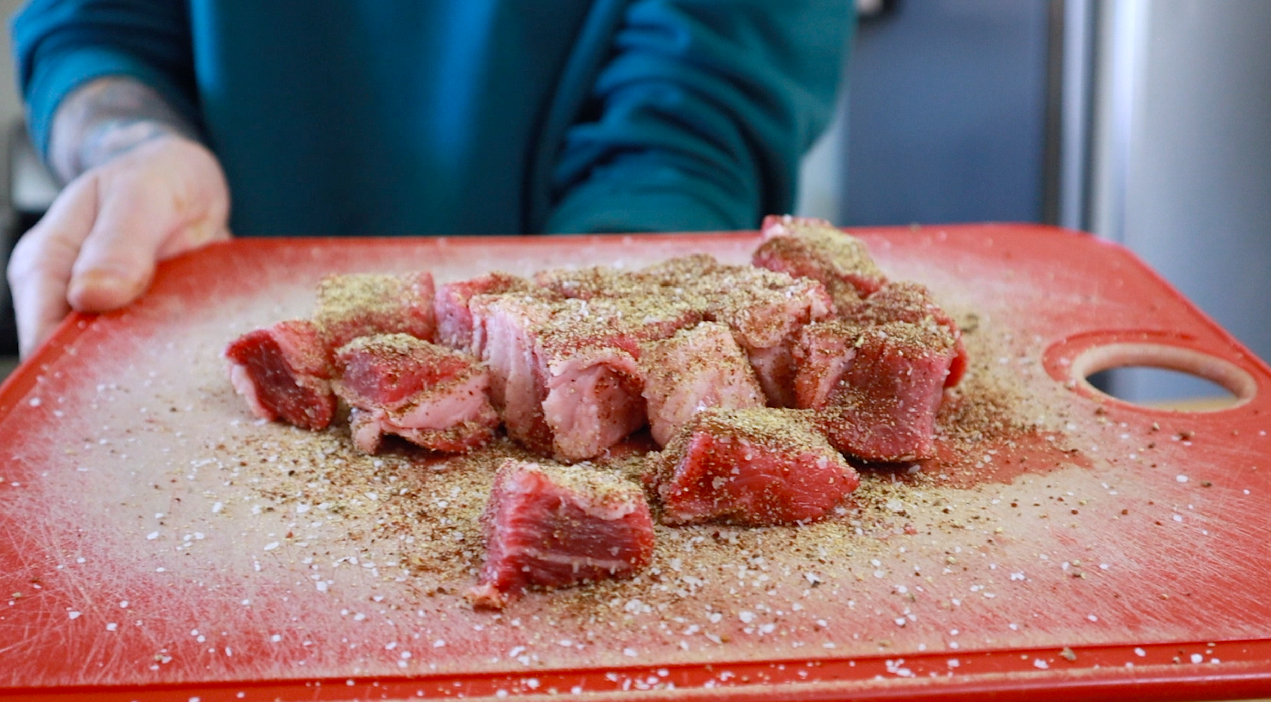 steak bites with seasoning on cutting board