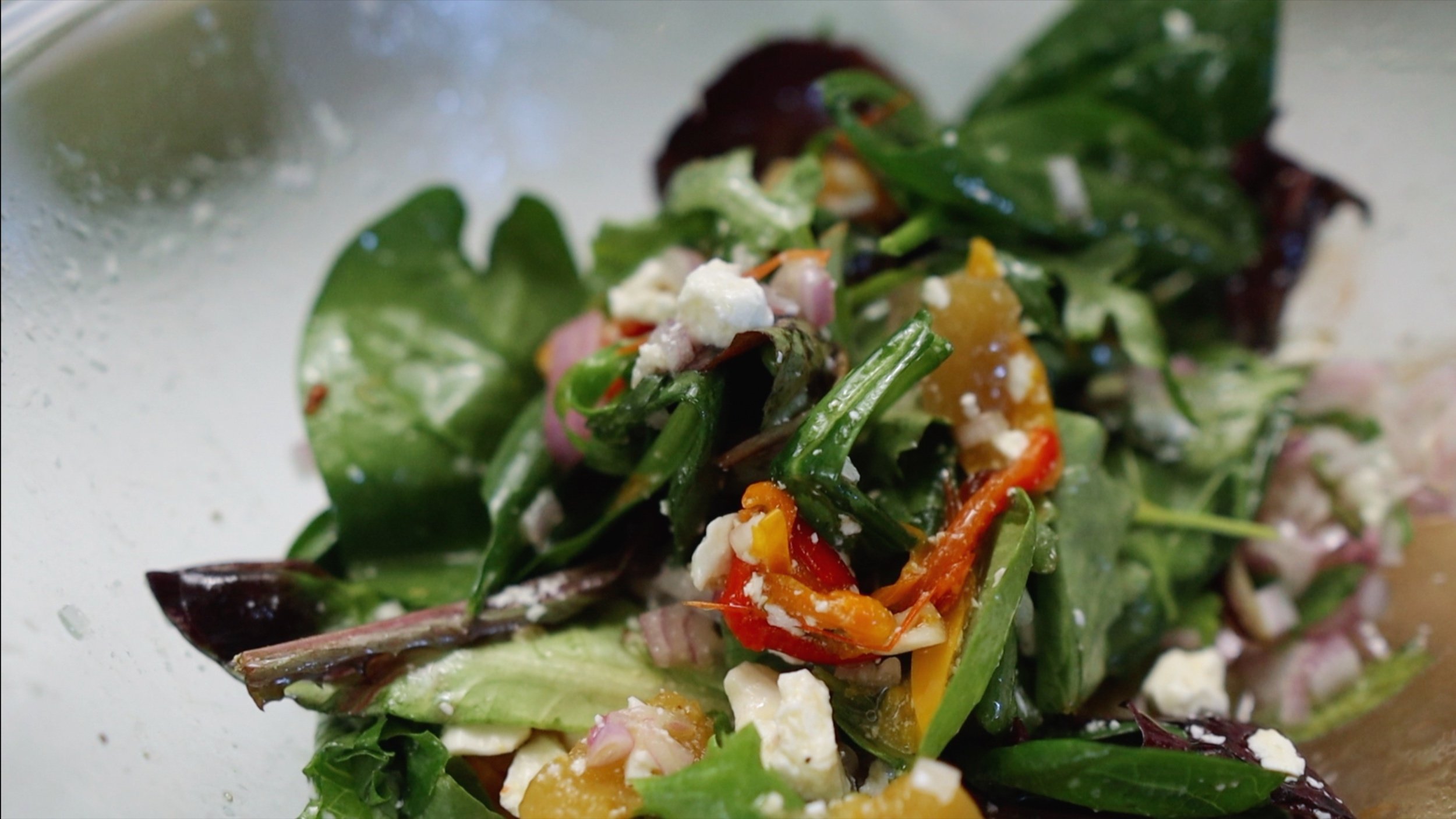 Arugula feta salad with fermented pumpkin, roasted sweet peppers and rice vinaigrette