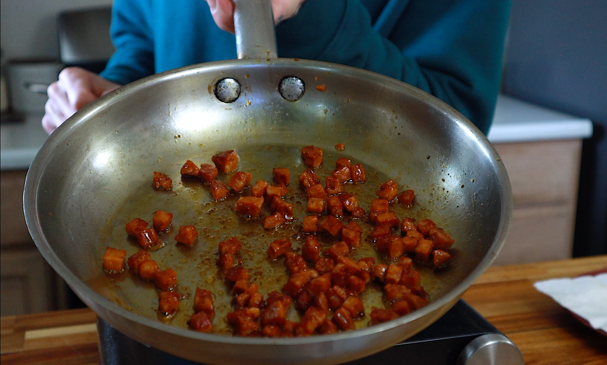 linguica getting rendered in a saute pan for the dutch baby