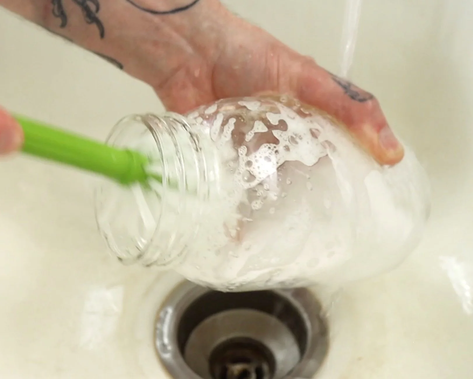 Washing mason jar with hot soapy water