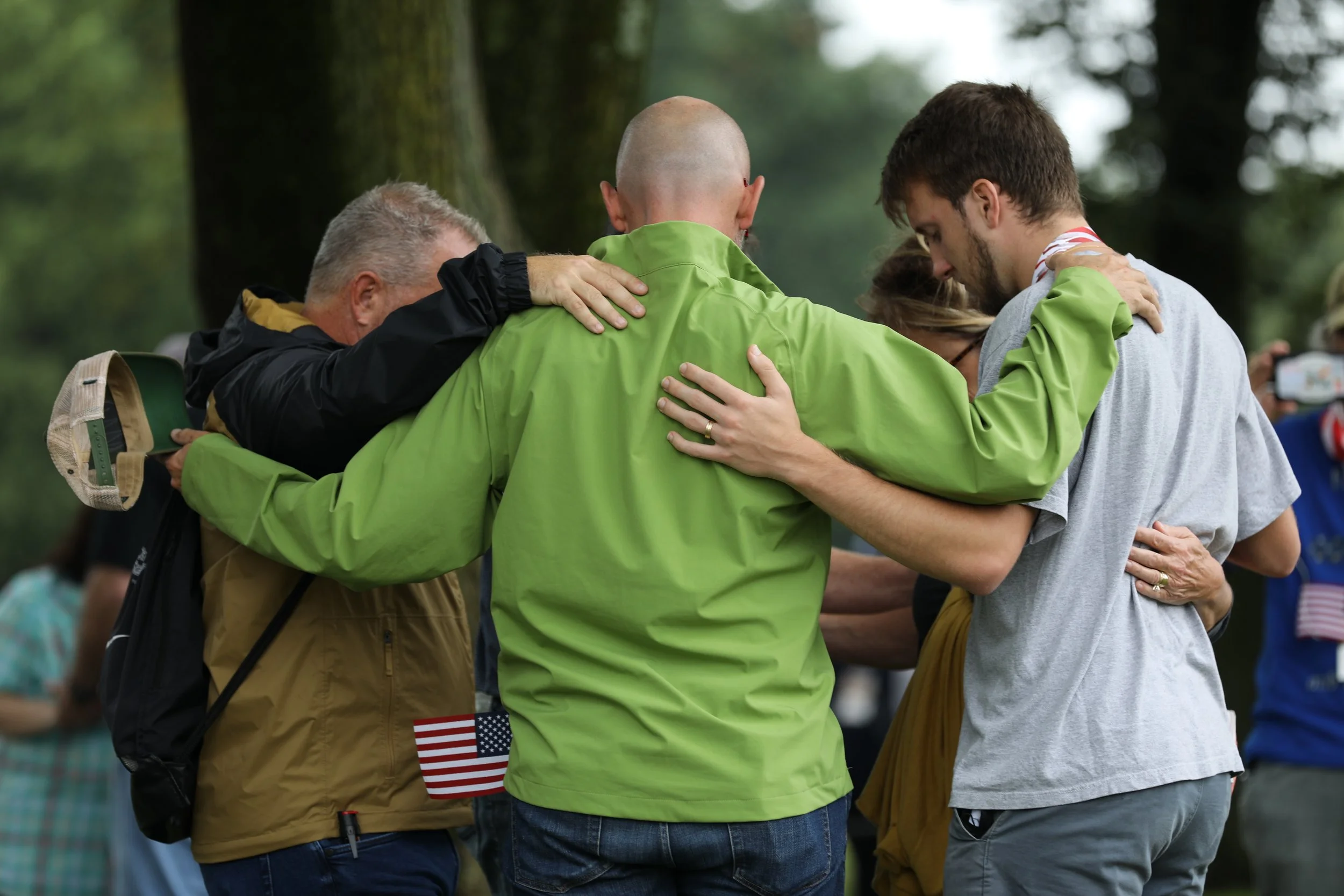 Green Jacket Group Praying.JPG