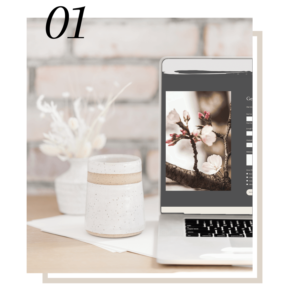 laptop showing website template in front of white brick wall
