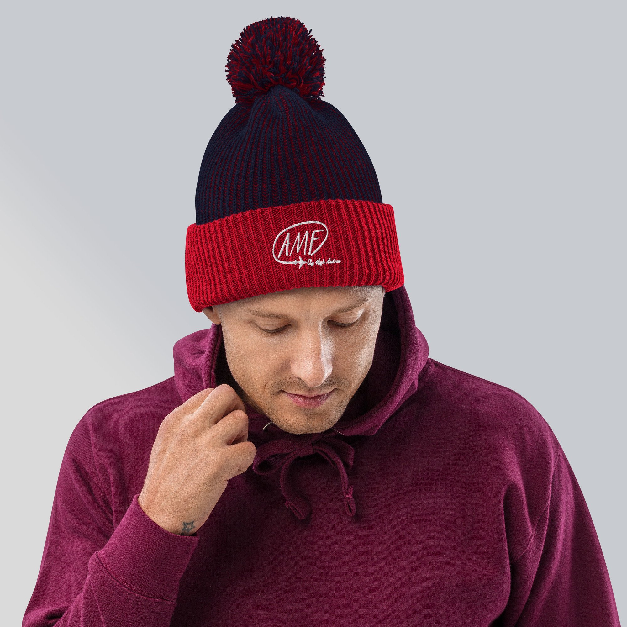 speckled-pom-pom-beanie-navy-red-front-638e58958bb13.jpg