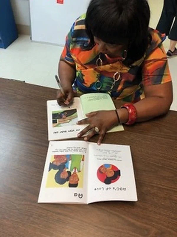 daphne-tillman-perry-signing-a-book.jpg