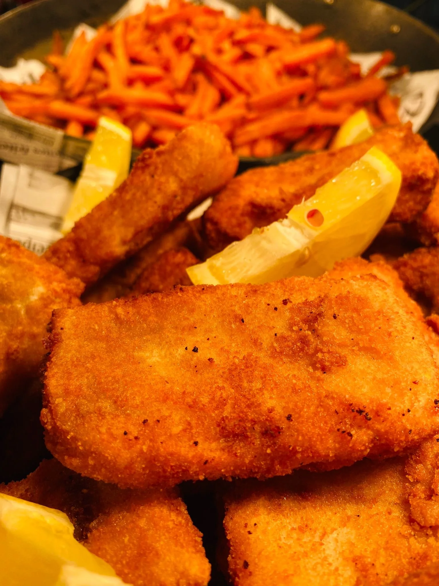 Close-up of toasted bread slices topped with cherry tomatoes, chopped red onions, and basil leaves.