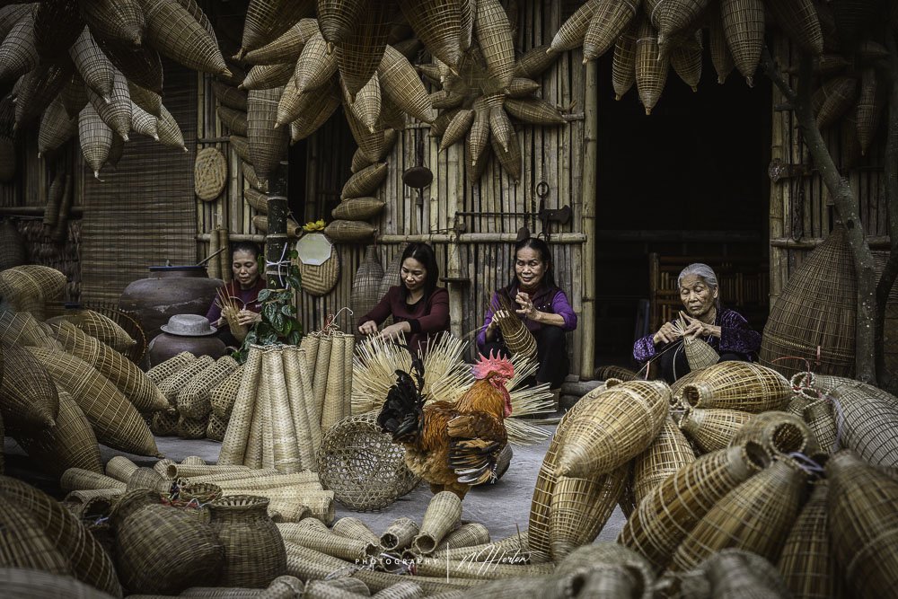 Women weaving in courtyard near Hanoi, Vietnam