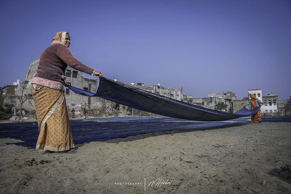 Women dries fabric Bagra Village Rajasthan India