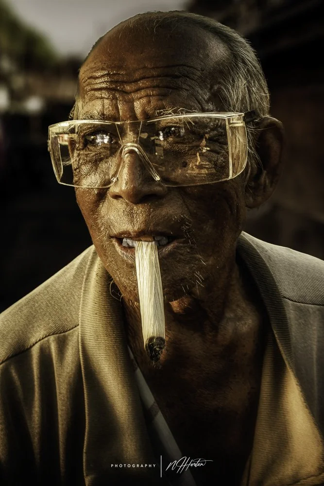 Portrait of old man with cigar in Indonesia