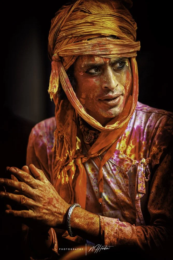 Man-covered-in-paint-at-Holi-festival-Nandgoan-India