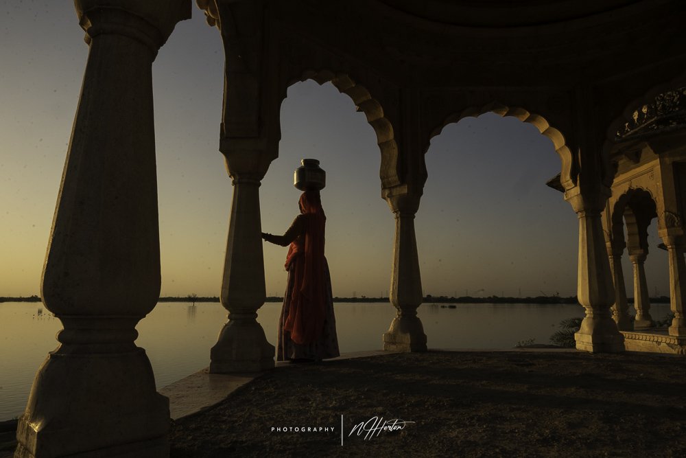 Lady-collecting-water-at-sunset-Rajasthan-India.