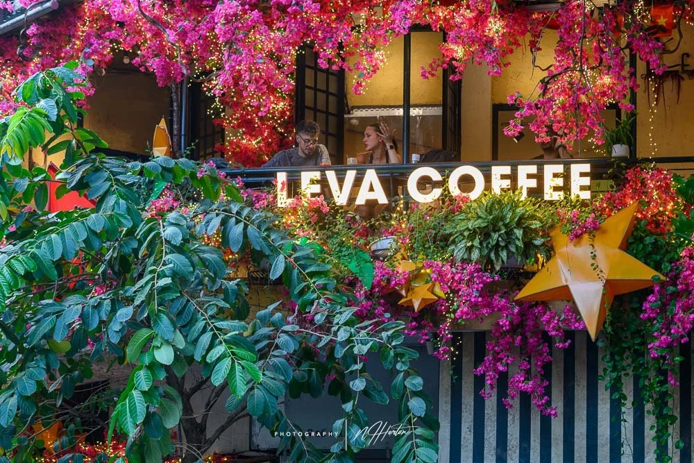 Couple drinking coffee in cafe, Hanoi, Vietnam.