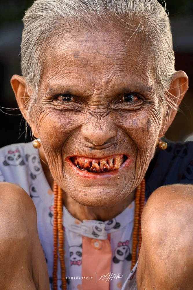 Portrait of Indonesian woman with red teeth in Sumba