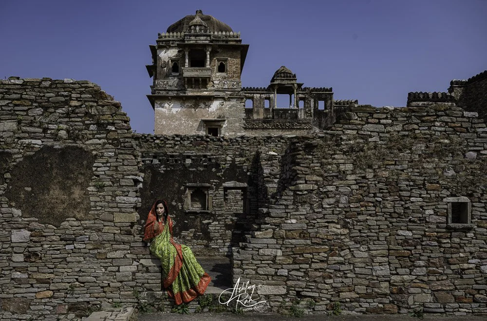 Lady sat on wall Chittorgarh fort, Rajasthan, India