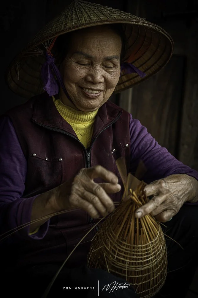 Portrait of lady making fishing basket, North Vietnam.