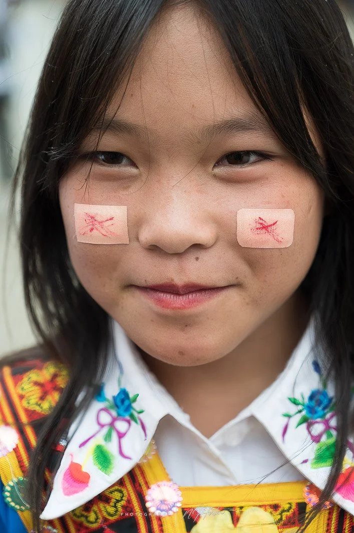 Young girl with decoration on face North Vietnam