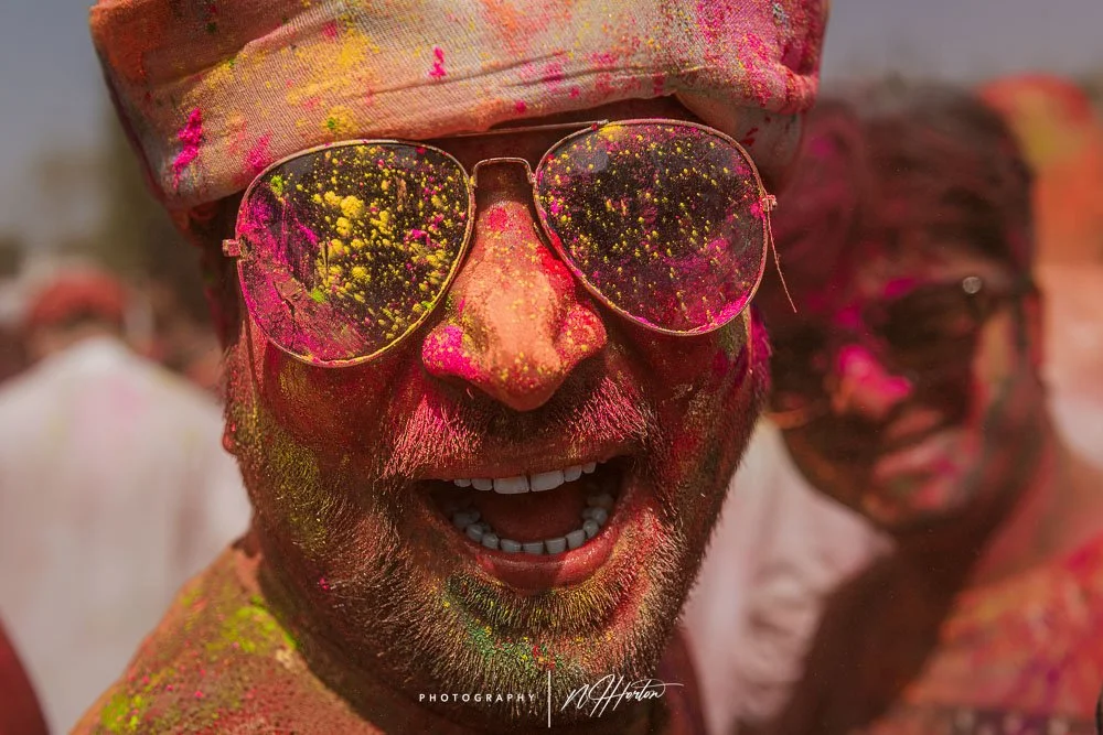 Man covered in colourful paint during Holi fetival India