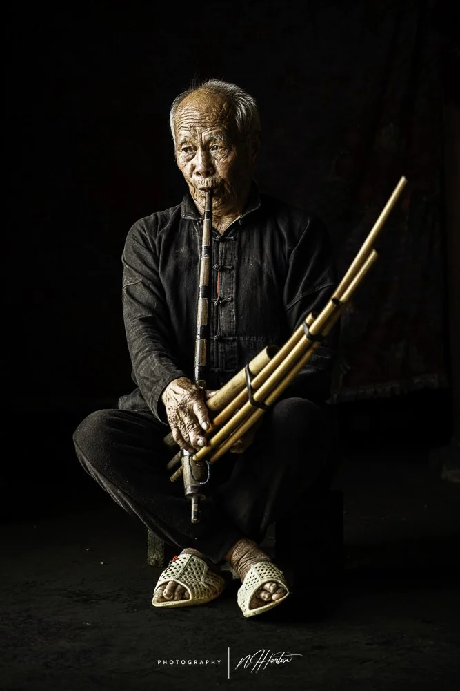Hmong Man playing music pipes Ha Giang