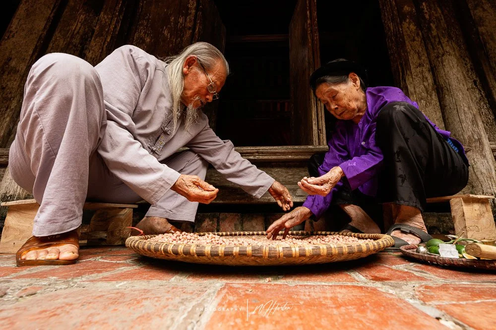 Man and woman working in ancient village, North Vietnam.