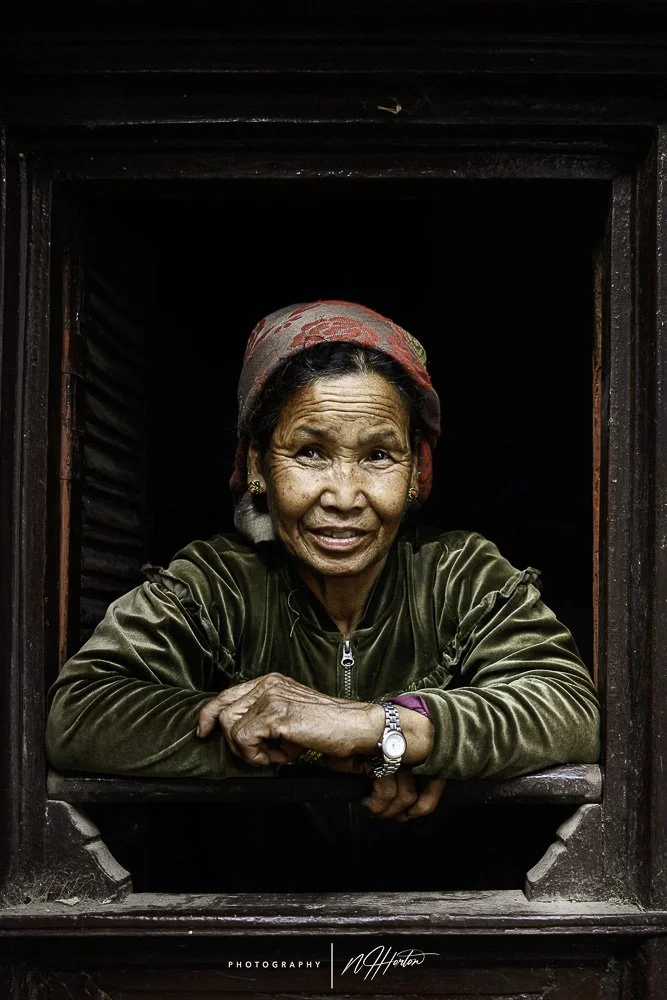 Portrait of lady in window, lower Mustang, Nepal