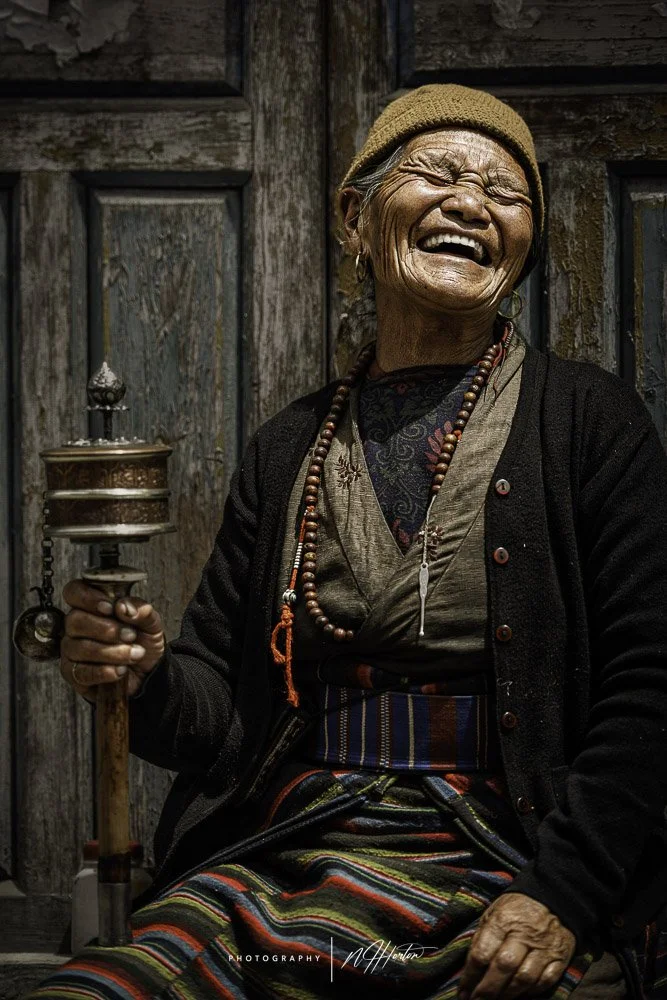 Portrait of lady with prayer wheel in Mustang, Nepal
