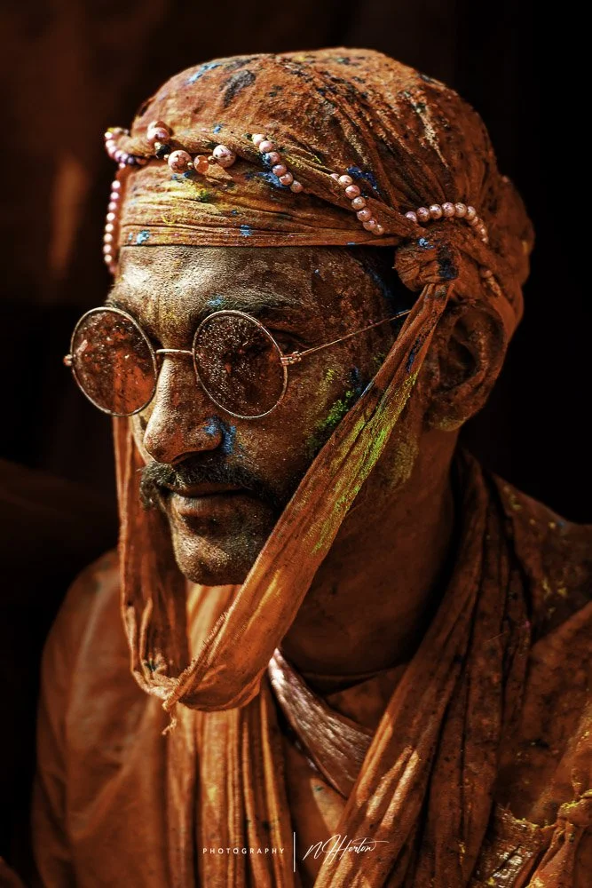 Man-covered-in-paint-at-Holi-festival-Nandgoan-India
