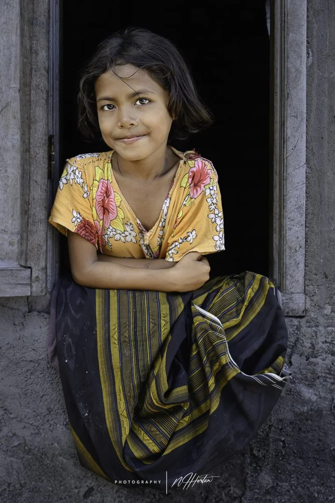 Portrait of Indonesian girl in window in Flores
