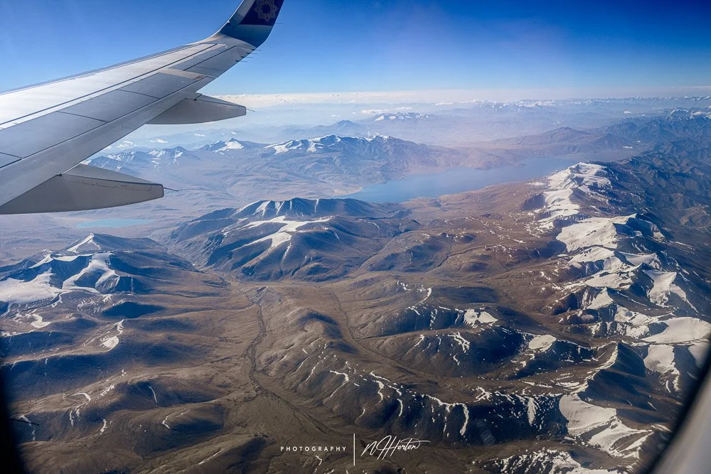 Snow peaked mountains from plane window Leh, India