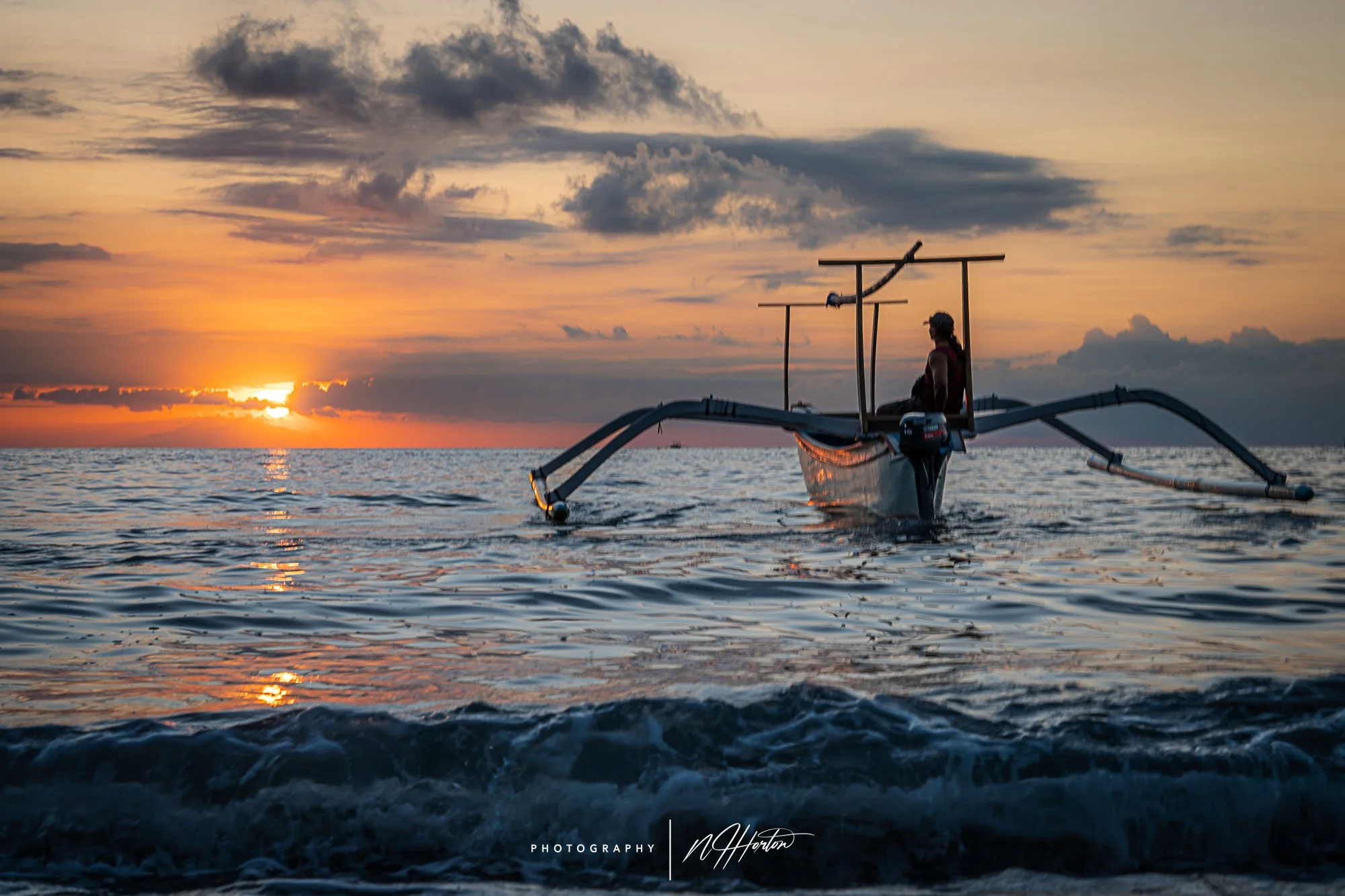 Boat at sunset on Lovina Beach, Bali, Indonesia.
